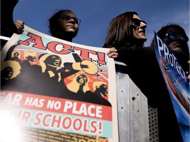 Students and parents from Marjory Stoneman Douglas High School hold signs during the "March for Our Lives" rally in support of gun control in Washington, Saturday, March 24, 2018.