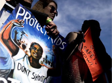 Students and parents from Marjory Stoneman Douglas High School hold signs during the "March for Our Lives" rally in support of gun control in Washington, Saturday, March 24, 2018.