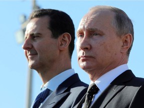 his Dec. 11, 2017 file photo, shows Russian President Vladimir Putin, right, and Syrian President Bashar Assad.