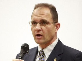 File - In this Oct. 4, 2010, file photo, Seaside City Council member Dennis Alexander speaks during an election forum in Seaside, Calif. Alexander, teacher and Mayor Pro-tem in Northern California accidentally fired his gun in a classroom, injuring three students, police said. Alexander, who is also a reserve police officer, was pointing the gun at the ceiling to make sure it was not loaded when the weapon discharged Tuesday, March 13, 2018, inside his classroom at Seaside High School, KSBW-TV reported. The Seaside Police Department said no one suffered "serious injuries.