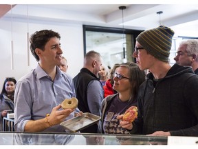 Prime Minister Justin Trudeau talks with the owners of Donut Monster, a business located on Locke Street in Hamilton Ont., Tuesday, March 13, 2018.