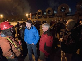 Prime Minister Justin Trudeau speaks with workers at the Essar Steel Algoma plant during a visit to Sault Ste. Marie, Ont., on Wednesday, March 14, 2018.