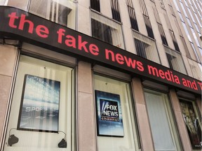 News headlines scroll above the Fox News studios in the News Corporation headquarters building in New York, Tuesday, Aug. 1, 2017.