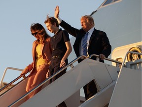 President Donald Trump, first lady Melania Trump and their son Barron Trump arrive on Air Force One at Palm Beach International Airport in Florida on Friday.