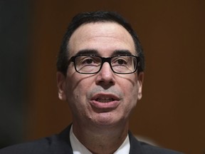 In this Feb. 14, 2018 photo, Treasury Secretary Steven Mnuchin testifies before the Senate Finance Committee on Capitol Hill in Washington. The Trump administration accused Russia on Thursday of a concerted, ongoing operation to hack and spy on the U.S. energy grid and other critical infrastructure.