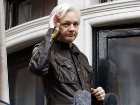 WikiLeaks founder Julian Assange greets supporters from a balcony of the Ecuadorian embassy in London on May 19, 2017.