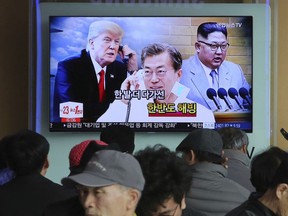 FILE - In this March 7, 2018 file photo, People watch a TV screen showing images of North Korean leader Kim Jong Un, right, South Korean President Moon Jae-in, center, and U.S. President Donald Trump at the Seoul Railway Station in Seoul, South Korea. Korean letters on the screen read: "Thawing Korean Peninsula." After six years of seclusion, it appears North Korean leader Kim Jong Un has decided it's time to get out and see the world. Kim made his international debut as his country's leader this week when he paid a surprise visit to Beijing for a summit with Chinese President Xi Jinping. It was the first time he is known to have traveled outside of his country since he assumed power in 2011. But Beijing was just the start of a very ambitious coming out party on the world stage for the enigmatic North Korean ruler. (