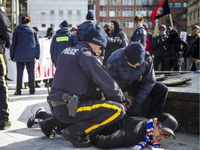RCMP officers handcuff Brandon Vaughan during a Parliament Hill 'Hijab Hoax' protest in February.
