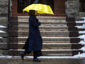 A woman walks along Elgin Street as Ottawa was hit with freezing rain.