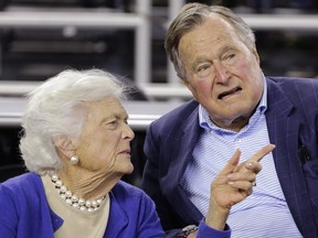 FILE - In this March 29, 2015, file photo, former President George H.W. Bush and his wife, Barbara Bush, speak at a college basketball game in Houston.