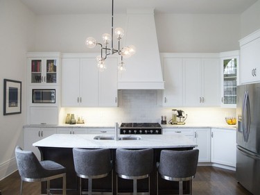 Denise Hulaj tweaked the kitchen, redesigning the hood fan to make it more dramatic and extending the height of the cabinets to match the architectural feel of the space.