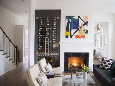 Denise and Steve Hulaj's Westboro home is ideal for entertaining and family meals in the expansive contemporary kitchen and sitting area with built-in wine cellar and fireplace. The artwork titled Elizabeth is by artist Lola and available at Renwil.