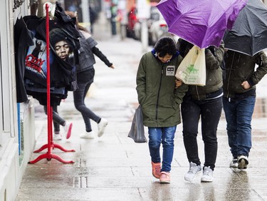 Sunday afternoon Ottawa was just starting to see the effects of the winter storm that has hit other parts of Ontario hard. Pedestrians hustle as they make their way through the market as the rain and freezing rain started to hit the capital Sunday April 15, 2018.   Ashley Fraser/Postmedia