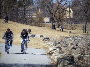 The warm sunshine has come out over Ottawa Saturday April 21, 2018, getting people outside for one of the first tastes of spring the city has had. Cyclists bike along the path in Andrew Haydon Park Saturday morning.