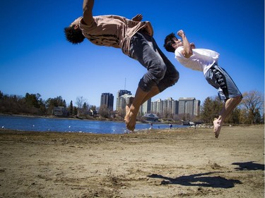 Warmer temperatures hit Ottawa Sunday April 22, 2018 and people were out and about enjoying the sunshine at Mooney's Bay Park. L-R Sheldon Morgan and Brandon Azzie were working on their parkour tricks on the beach Sunday afternoon in the warm sunshine.