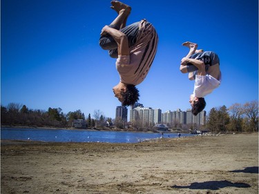 Warmer temperatures hit Ottawa Sunday April 22, 2018 and people were out and about enjoying the sunshine at Mooney's Bay Park. L-R Sheldon Morgan and Brandon Azzie were working on their parkour tricks on the beach Sunday afternoon in the warm sunshine.