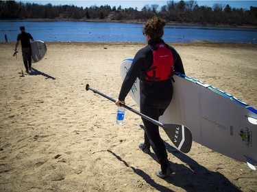 Warmer temperatures hit Ottawa Sunday April 22, 2018 and people were out and about enjoying the sunshine at Mooney's Bay Park. L-R Kevin Payan and Emma Bédard were all geared up and ready to get their boards out on the water as the warmer temperatures hit the capital this weekend.