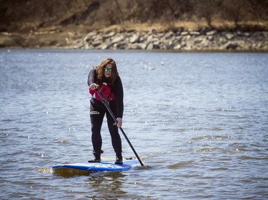 Warmer temperatures hit Ottawa Sunday April 22, 2018 and people were out and about enjoying the sunshine at Mooney's Bay Park. Emma Bédard kicking off the paddling season on her standup paddle board Sunday afternoon.