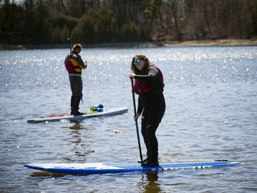 Warmer temperatures hit Ottawa Sunday April 22, 2018 and people were out and about enjoying the sunshine at Mooney's Bay Park. L-R Kevin Payan and Emma Bédard were all geared up and ready to get their boards out on the water as the warmer temperatures hit the capital this weekend.