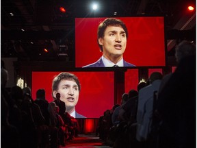 Video screens show Prime Minister Justin Trudeau as he delivers a speech at the federal Liberal national convention in Halifax on Saturday, April 21, 2018.