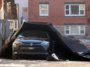 A roof was peeled off a row of townhouses on Osgoode Street in Sandy Hill Wednesday as winds gusted at up to 90 km/h. The roofing from three to four units fell on a car and some back decks in the alley behind the homes.