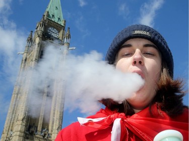 Jakob Solmes, 18, exhales from his bong. It was the annual 4/20 rally on Parliament Hill Friday as hundreds gathered to smoke pot and celebrate cannabis culture.  Organizers of this year's rally say it's a celebration and a protest: a celebration for the forthcoming legalization of pot this summer and a protest of the government's strict regulations surrounding that.  Julie Oliver/Postmedia
