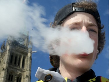Liam Milne, 18, exhales on the hill. It was the annual 4/20 rally on Parliament Hill Friday as hundreds gathered to smoke pot and celebrate cannabis culture.  Organizers of this year's rally say it's a celebration and a protest: a celebration for the forthcoming legalization of pot this summer and a protest of the government's strict regulations surrounding that.  Julie Oliver/Postmedia