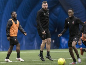 Fury FC defender Colin Falvey, middle, in action during an indoor practice in March. Most workouts this season have been under a dome because of weather conditions in Ottawa. Errol McGihon/Postmedia