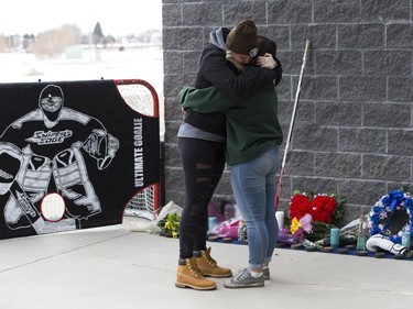 Carly Zimmer, left, and Jessica Johnson console each other at a memorial for their friend Stephen Wack outside Athletes Nation One gym, in St. Albert Saturday April 7, 2018.