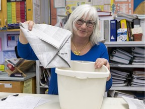 Janet Perry is a science teacher at Frederick Banting Secondary Alternate Program in Stittsville. The school has been making green bin liners out of recycled Citizen newspapers for years. (Photo: Errol McGihon/Postmedia)