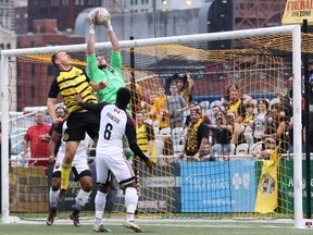 Fury FC goalkeeper Maxime Crépeau, middle, leaps high above a crowd of players to pull in the ball during Saturday's match against the Riverhounds. Chris Cowger phoo