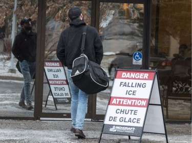 A man makes his way in to an office building in Ottawa during a severe spring storm. April 16,2018. Errol McGihon/Postmedia