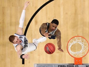 Donte DiVincenzo #10 of the Villanova Wildcats drives to the basket against Charles Matthews #1 of the Michigan Wolverines in the second half during the 2018 NCAA Men's Final Four National Championship game at the Alamodome on April 2, 2018 in San Antonio, Texas.