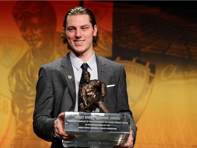 Adam Gaudette of Northeastern University and the Vancouver Canucks poses with the Hobey Baker Memorial Award during the ceremony in St. Paul, Minn., on Friday.