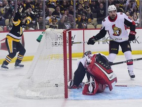 Penguins star Sidney Crosby, left, celebrates after scoring a goal against the Senators in the second period of Friday's game in Pittsburgh.