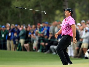 Patrick Reed of the United States tosses his club on the 17th green during the final round of the 2018 Masters Tournament at Augusta National Golf Club on April 8, 2018 in Augusta, Georgia.