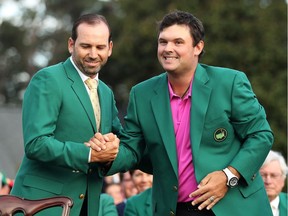 Patrick Reed (R) of the United States is congratulated by Sergio Garcia (L) of Spain after being presented the green jacket after winning the 2018 Masters Tournament at Augusta National Golf Club on April 8, 2018 in Augusta, Georgia.