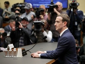 Facebook Chairman and CEO Mark Zuckerberg is surrounded by cameras as he prepares to testify before the U.S. House Energy and Commerce Committee on Capitol Hill April 11.