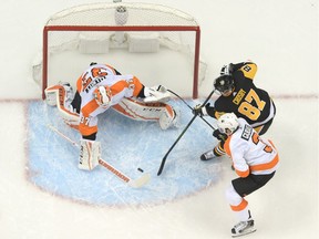 Brian Elliott of the Philadelphia Flyers makes a save on a shot attempt by Sidney Crosby of the Pittsburgh Penguins.