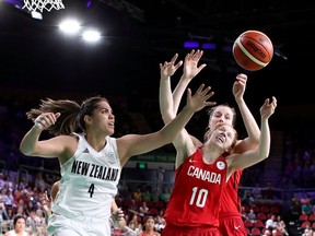 Catherine Traer of Chelsea and Kalani Purcell of New Zealand compete for the ball during the women's basketball bronze-medal game on Saturday.