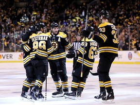David Pastrnak #88 of the Boston Bruins, right, celebrates with Patrice Bergeron #37, Brad Marchand #63 and Zdeno Chara #33 after scoring a goal against the Toronto Maple Leafs during the third period of Game Two of the Eastern Conference First Round during the 2018 NHL Stanley Cup Playoffs(