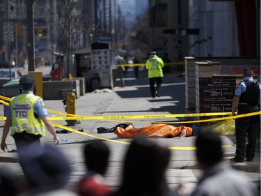 TORONTO, ON - APRIL 23: A tarp lies on top of a body on Yonge St. at Finch Ave. after a van plowed into pedestrians on April 23, 2018 in Toronto, Canada. A suspect is in custody after a white van collided with multiple pedestrians.