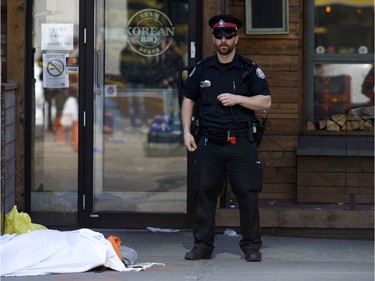 TORONTO, ON - APRIL 23:  A tarp covers an unidentiified body on Yonge St. at Finch Ave. after a van plowed into pedestrians on April 23, 2018 in Toronto, Ontario, Canada. A suspect is in custody after a white van collided with multiple pedestrians killing nine and injuring at least 16.