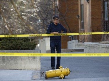 TORONTO, ON - APRIL 23: A man stands by a dislodged fire hydrant on Yonge St. at near Finch Ave., after a van plowed into pedestrians on April 23, 2018 in Toronto, Canada. A suspect identified as Alek Minassian, 25, is in custody after a driver in a white rental van collided with multiple pedestrians killing nine and injuring at least 16.