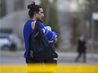 TORONTO, ON - APRIL 23: People embrace at the scene on Yonge St. at Finch Ave., after a van plowed into pedestrians on April 23, 2018 in Toronto, Canada. A suspect identified as Alek Minassian, 25, is in custody after a driver in a white rental van collided with multiple pedestrians killing nine and injuring at least 16.