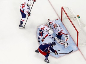 Braden Holtby #70 of the Washington Capitals stops a shot from Matt Calvert #11 of the Columbus Blue Jackets as Chandler Stephenson #18 of the Washington Capitals looks to clean up the rebound during the second period in Game Six of the Eastern Conference First Round during the 2018 NHL Stanley Cup Playoffs on April 23, 2018 at Nationwide Arena in Columbus, Ohio. Washington defeated Columbus 6-3 to win the series 4-2.