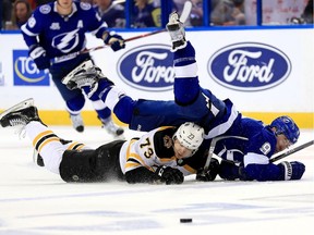 Tyler Johnson #9 of the Tampa Bay Lightning and Charlie McAvoy #73 of the Boston Bruins fight for the puck during Game Two of the Eastern Conference Second Round  during the 2018 NHL Stanley Cup Playoffs at Amalie Arena on April 30, 2018 in Tampa, Florida.