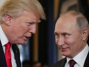 In this file photo taken on November 11, 2017 US President Donald Trump (L) chats with Russia's President Vladimir Putin as they attend the APEC Economic Leaders' Meeting.