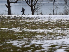 A man jogs along the banks of lake Woerthsee near the Bavarian village of Inning, as sun slowly with temperatures remaining at the freezing point on March 22, 2018.  Meteorologists forecast warmer weather for the upcoming days in southern Germany. / AFP PHOTO / CHRISTOF STACHECHRISTOF STACHE/AFP/Getty Images