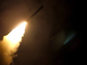 In this image released by the US Department of Defense the guided-missile cruiser USS Monterey fires a Tomahawk land attack missile on April 14, 2018.